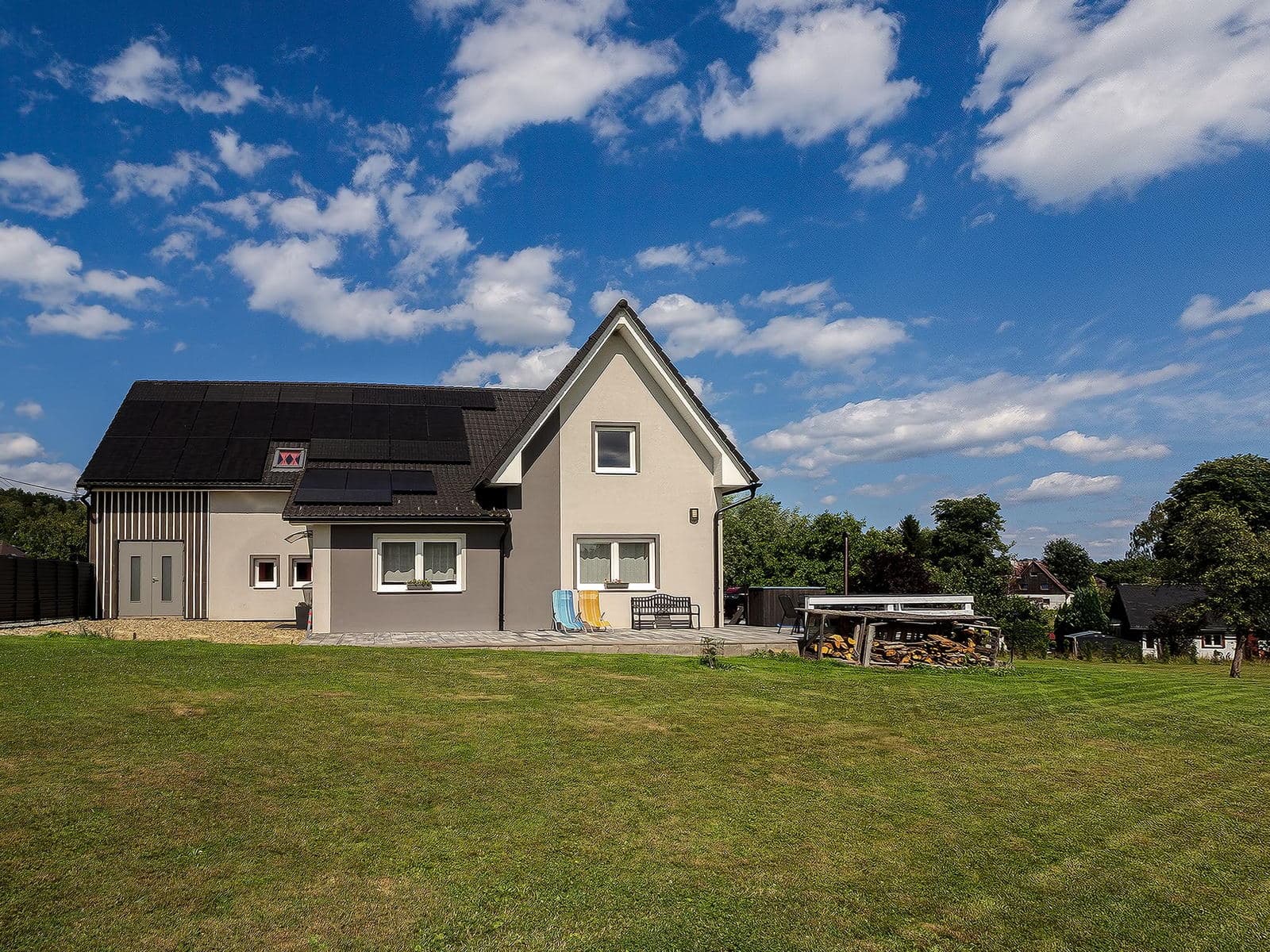 Back of the house with the utility wing and seating on the lawn